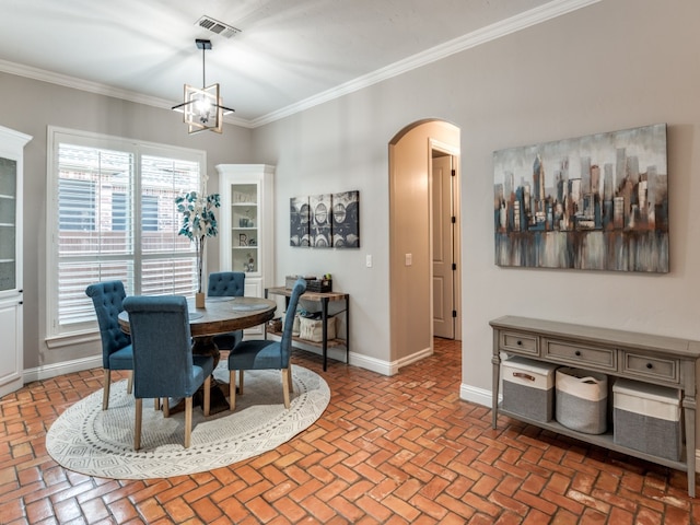 dining space featuring a notable chandelier, crown molding, and a wealth of natural light