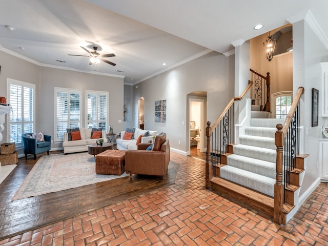 living room with crown molding and ceiling fan