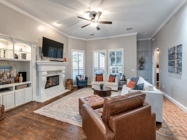 living room featuring ceiling fan, ornamental molding, and dark hardwood / wood-style flooring