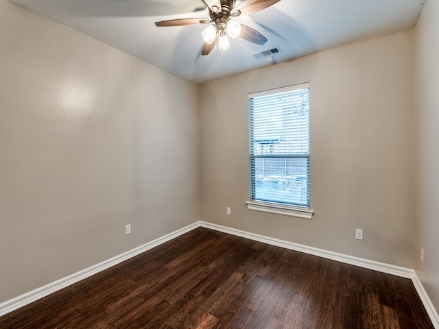 spare room with ceiling fan and dark wood-type flooring