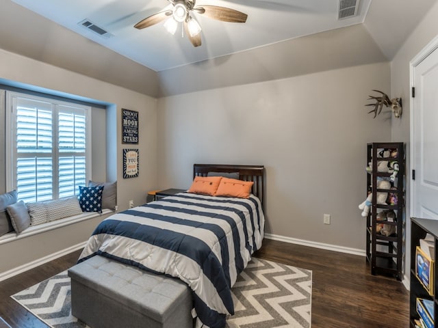 bedroom featuring dark hardwood / wood-style floors, vaulted ceiling, and ceiling fan