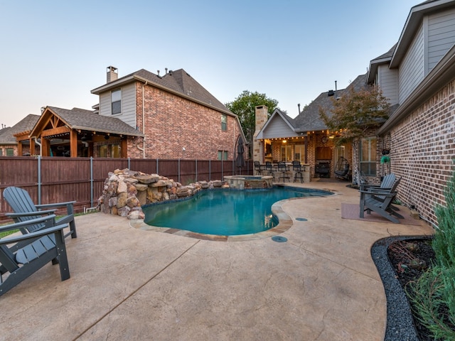 view of swimming pool with an in ground hot tub and a patio area