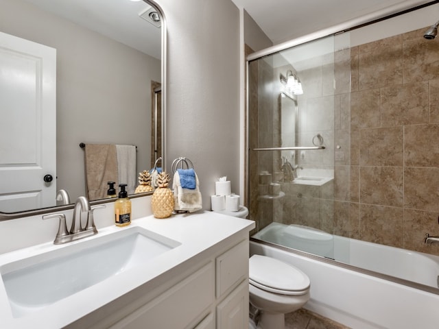 full bathroom featuring bath / shower combo with glass door, vanity, and toilet