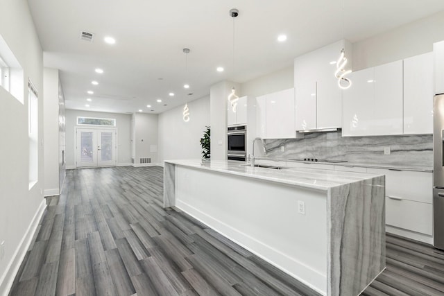 2507 Crossman Ave, Dallas, TX 75212 - kitchen featuring a sink, modern cabinets, white cabinetry, a large island, and dark wood-type flooring
