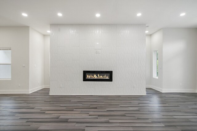 unfurnished living room with dark hardwood / wood-style flooring