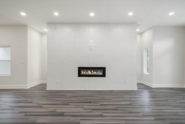 2507 Crossman Ave, Dallas, TX 75212 - unfurnished living room featuring baseboards, wood finished floors, recessed lighting, and a glass covered fireplace