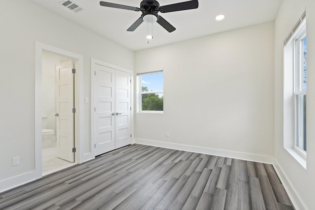 2507 Crossman Ave, Dallas, TX 75212 - unfurnished bedroom with wood finished floors, baseboards, recessed lighting, ensuite bath, and ceiling fan