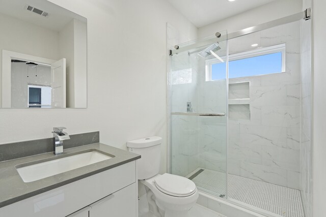 bathroom with walk in shower, vanity, and toilet