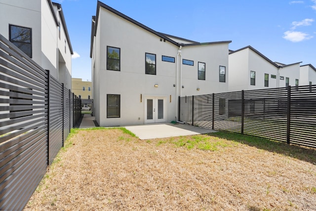 rear view of property with french doors and a patio area