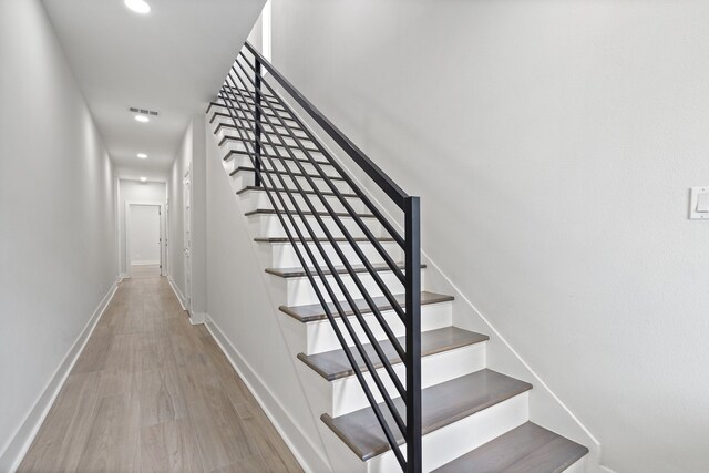 stairs with hardwood / wood-style flooring