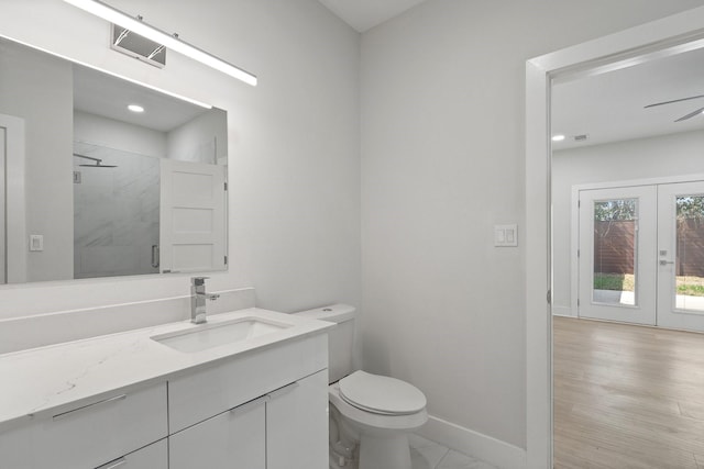 2507 Crossman Ave, Dallas, TX 75212 - full bath with a stall shower, toilet, vanity, french doors, and baseboards
