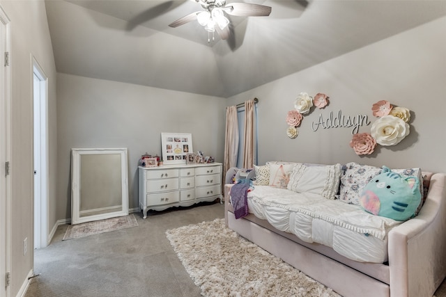 carpeted bedroom featuring lofted ceiling and ceiling fan