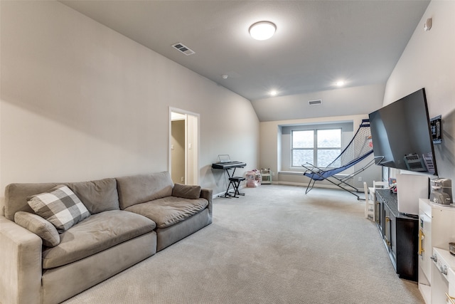 carpeted living room featuring lofted ceiling