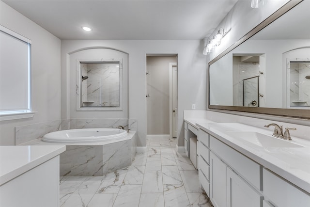 bathroom featuring vanity, separate shower and tub, and a healthy amount of sunlight