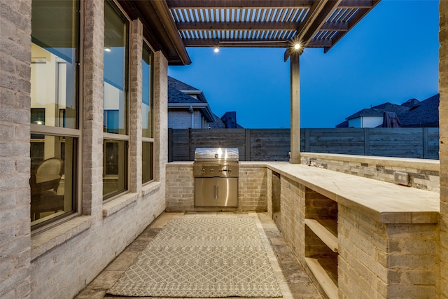 view of patio / terrace featuring area for grilling and a pergola