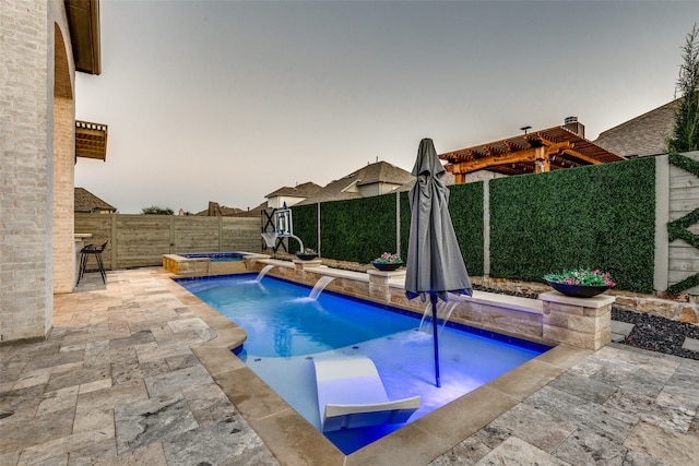 pool at dusk featuring a patio, pool water feature, an in ground hot tub, and a pergola