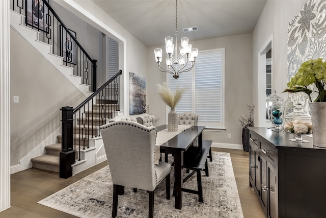 dining space featuring light hardwood / wood-style flooring and an inviting chandelier