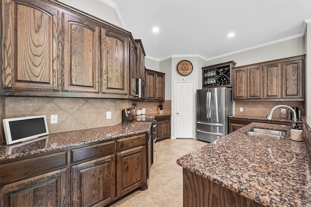 kitchen featuring dark brown cabinets, ornamental molding, sink, and appliances with stainless steel finishes