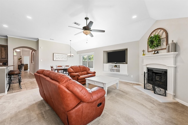 living room featuring ceiling fan with notable chandelier, light carpet, and vaulted ceiling