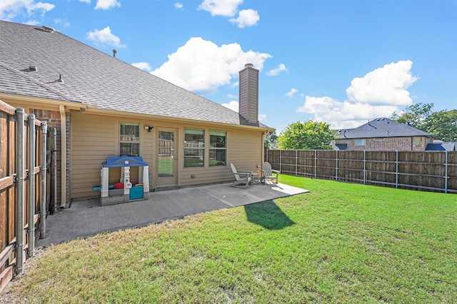 rear view of house with a patio and a lawn