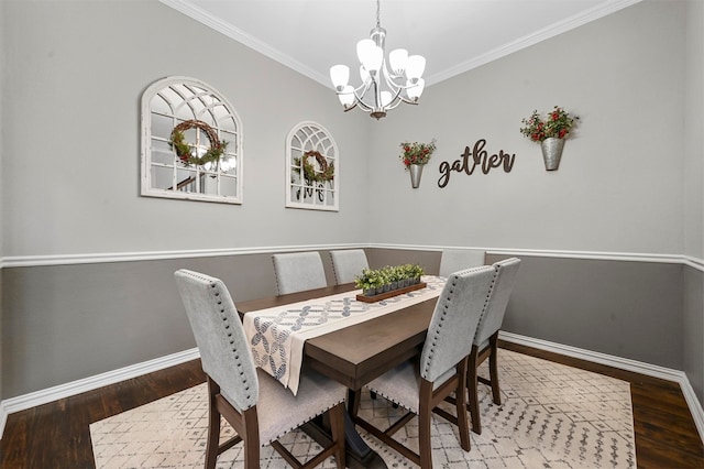 dining area with crown molding, wood-type flooring, and a notable chandelier