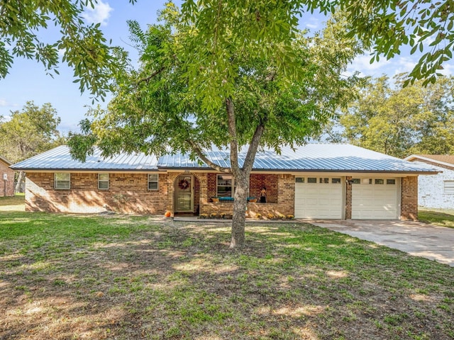 ranch-style house featuring a garage and a front lawn