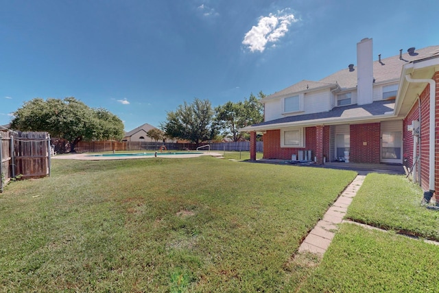 view of yard featuring a fenced in pool and a patio area