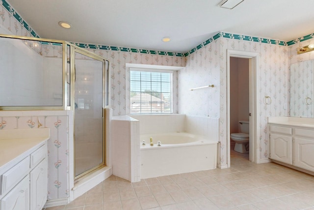 full bathroom featuring vanity, shower with separate bathtub, toilet, and tile patterned floors