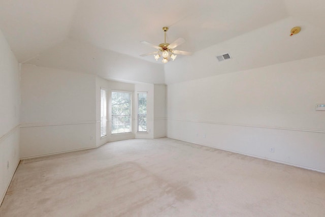 carpeted empty room featuring ceiling fan and lofted ceiling