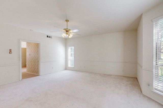 unfurnished room featuring ceiling fan and light colored carpet