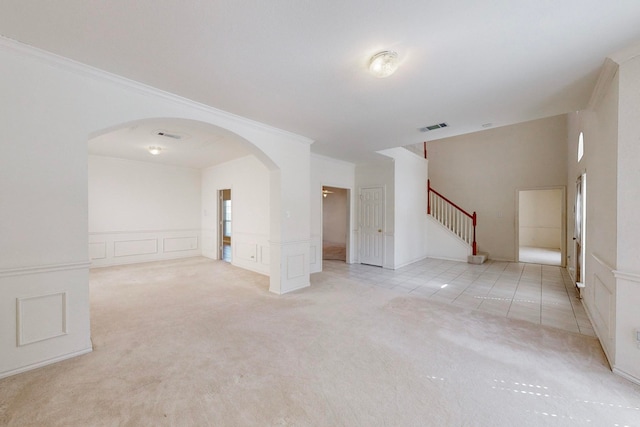 carpeted spare room featuring crown molding