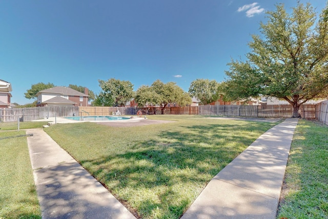 view of yard with a fenced in pool