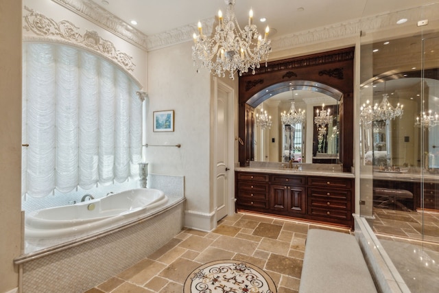 bathroom featuring ornamental molding, vanity, and tiled bath