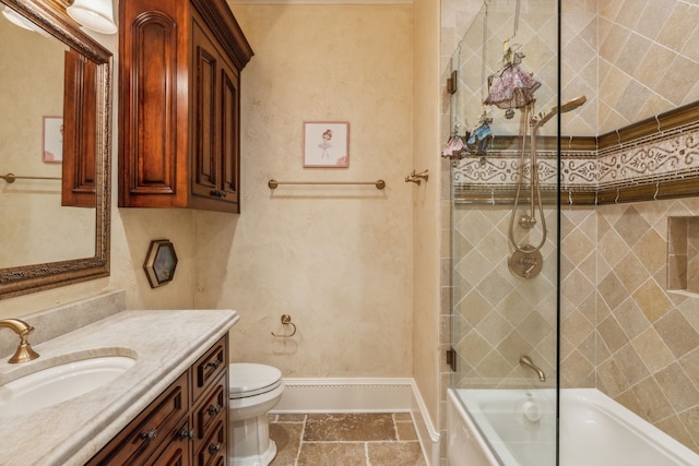 full bathroom featuring tiled shower / bath, vanity, and toilet