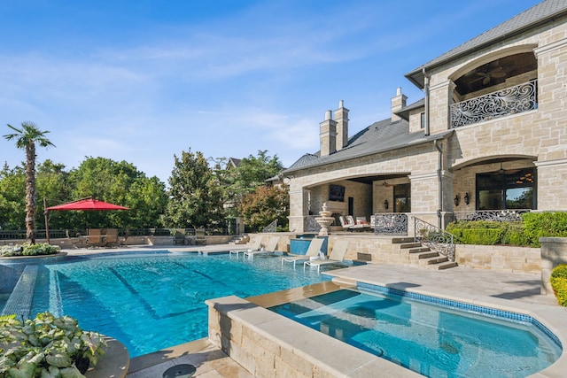 view of pool featuring an in ground hot tub and a patio