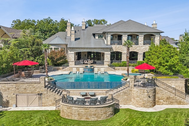 view of swimming pool featuring a lawn and a patio area