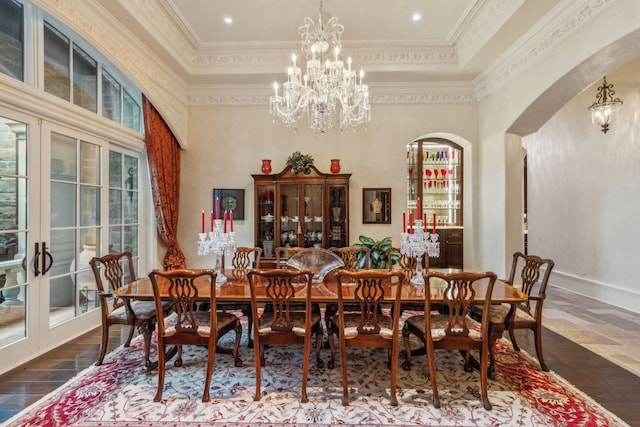 dining area with hardwood / wood-style flooring, crown molding, and plenty of natural light