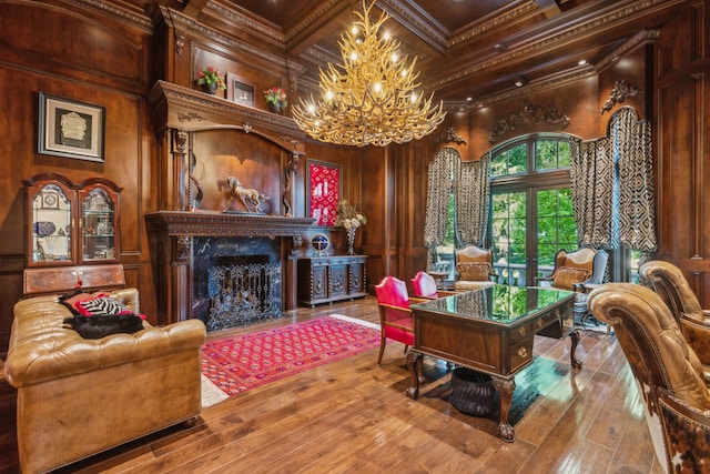 interior space with wooden walls, beamed ceiling, hardwood / wood-style floors, crown molding, and a fireplace