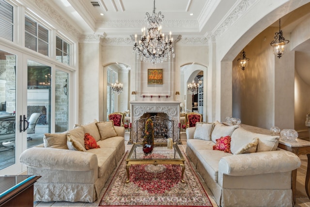 living room with crown molding, a tray ceiling, and a towering ceiling