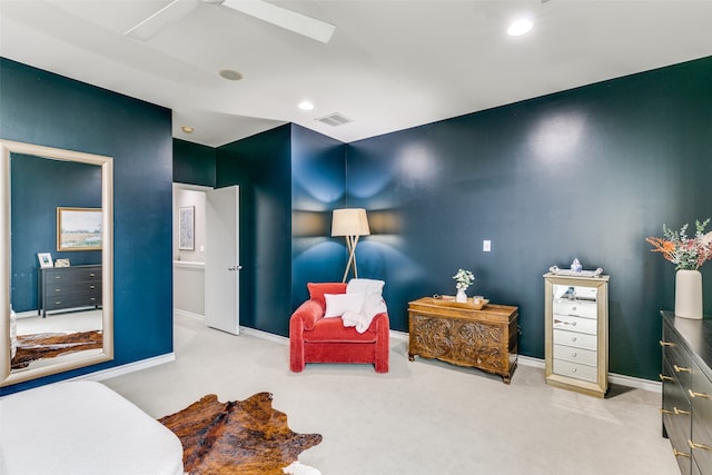 living area featuring ceiling fan and light colored carpet