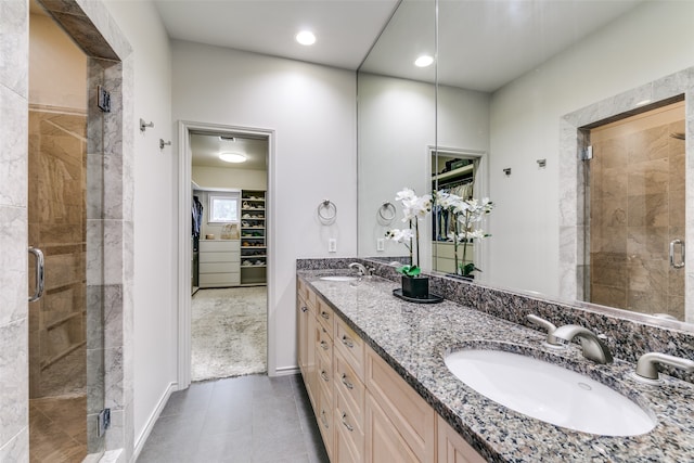 bathroom with tile patterned floors, vanity, and an enclosed shower