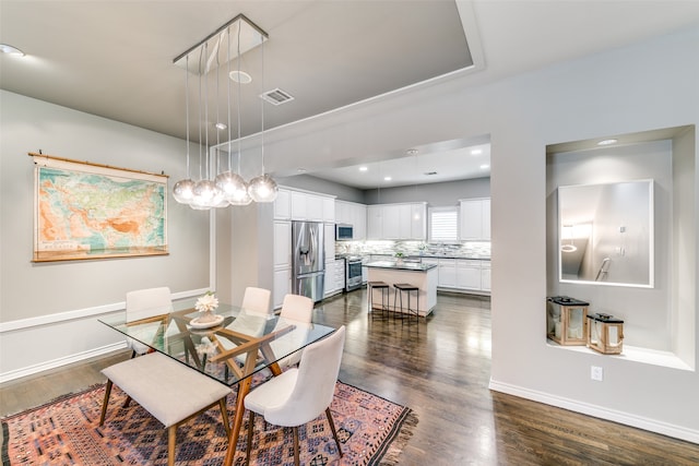 dining area featuring dark wood-type flooring