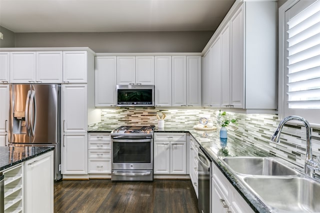 kitchen featuring white cabinetry, sink, stainless steel appliances, and dark hardwood / wood-style flooring