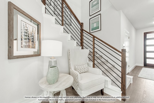 staircase with hardwood / wood-style flooring