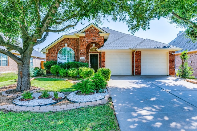 view of front of property featuring a garage and a front lawn