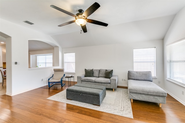 living room with vaulted ceiling, hardwood / wood-style flooring, and ceiling fan