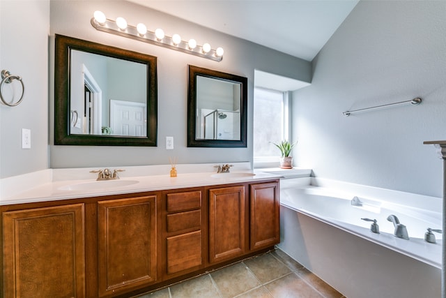 bathroom with tile patterned floors, vanity, and a washtub