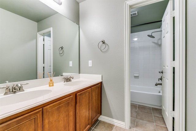 bathroom featuring vanity, tiled shower / bath combo, and tile patterned floors