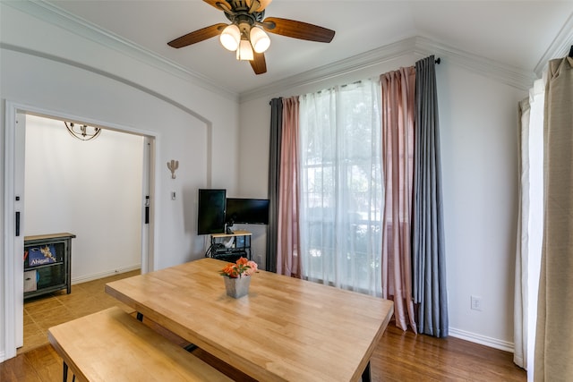 dining space featuring ceiling fan, hardwood / wood-style flooring, and ornamental molding