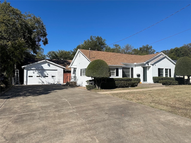 view of front of home featuring an outbuilding, a garage, and a front yard